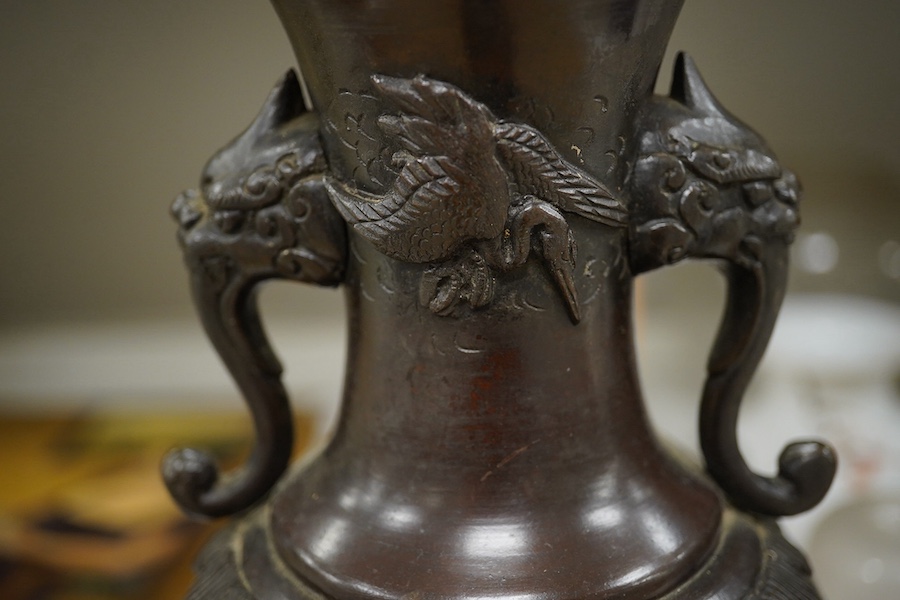 A Japanese bronze vase, converted to a lamp on carved wooden stand, 34.5cm high not including fitting. Condition - drilled to base